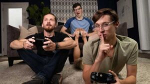 Harrison Todd gets horny while gaming with his buddy, but his friend would rather play solo than play with Harrison's joystick. As he sits on the couch, Shae Reynolds starts rubbing his shoulders